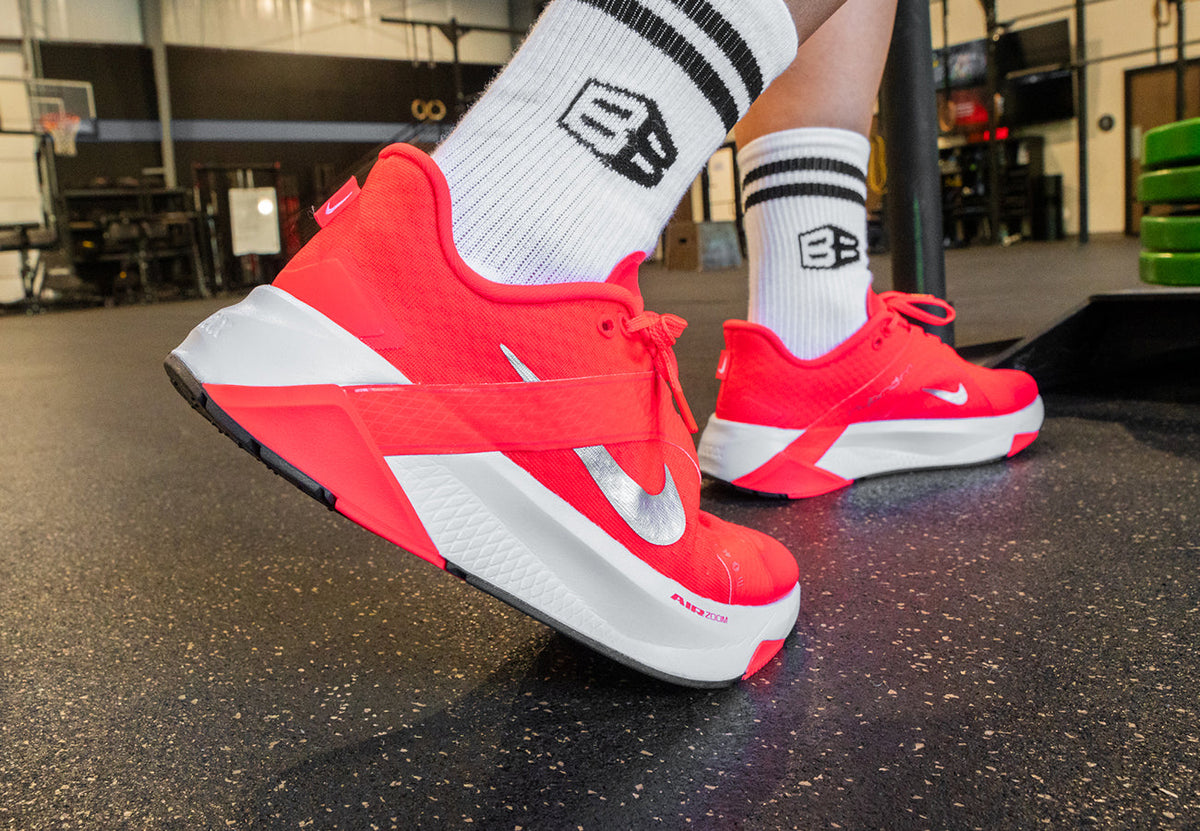 Athlete pushing weight sled in the Nike Hybrid RN 