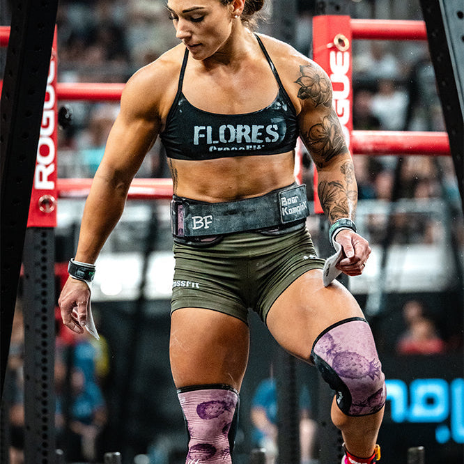 Athlete lifting weights at a crossfit event, wearing Bethany Flores signature bear komplex knee sleeves.